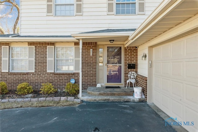 entrance to property featuring brick siding