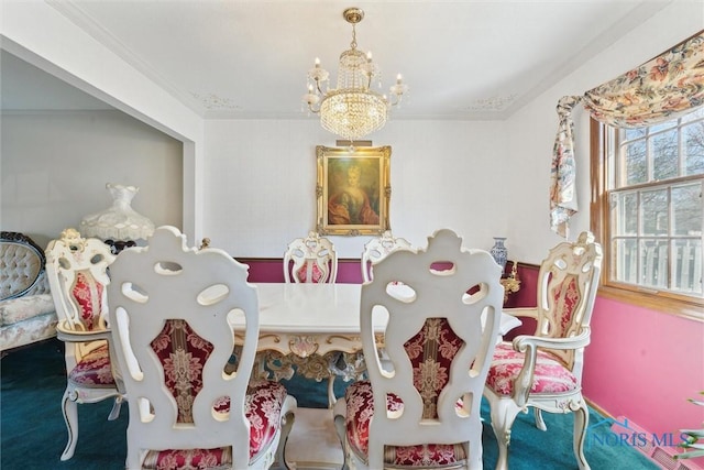 carpeted dining space featuring a notable chandelier and ornamental molding