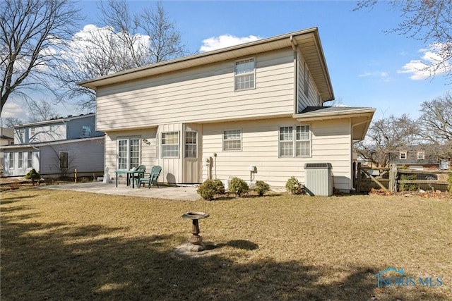 rear view of property with a patio, a lawn, fence, and central AC