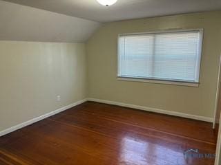 bonus room featuring lofted ceiling, baseboards, and wood finished floors