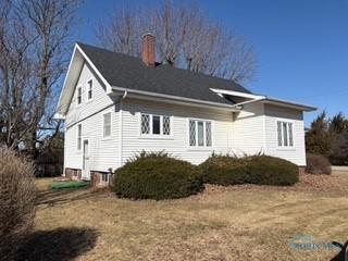 view of property exterior with a chimney