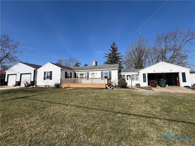 view of front of home with a front lawn, an attached garage, a chimney, and a wooden deck