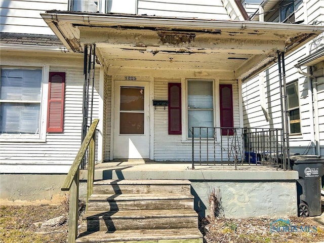 property entrance with covered porch