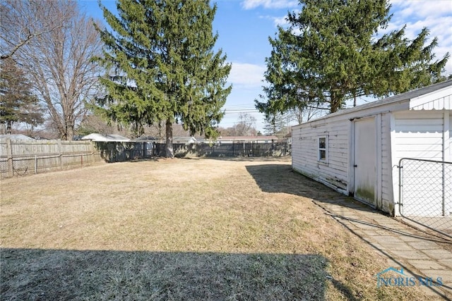 view of yard with an outdoor structure and a fenced backyard