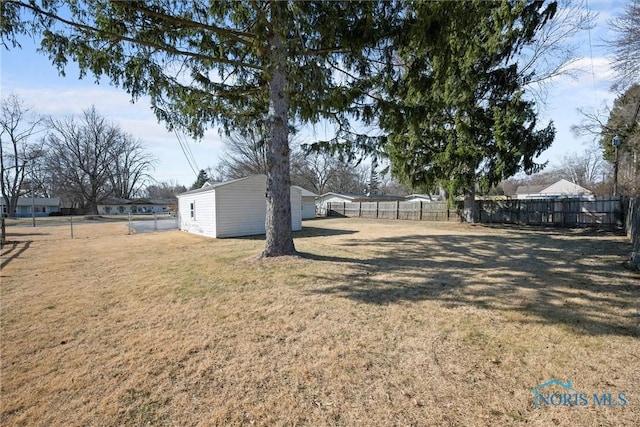 view of yard featuring an outbuilding and a fenced backyard