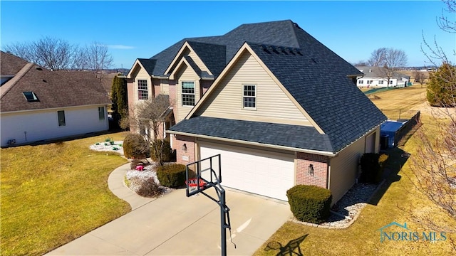 view of front of house with brick siding, a front lawn, concrete driveway, roof with shingles, and a garage