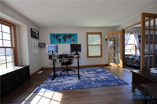 office space with baseboards and wood finished floors