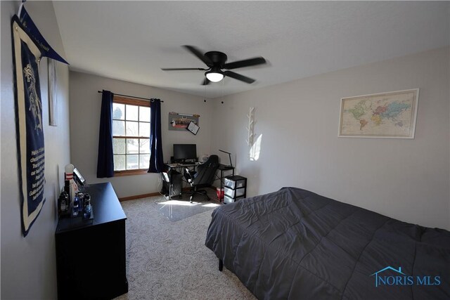 bedroom featuring baseboards, carpet floors, and a ceiling fan