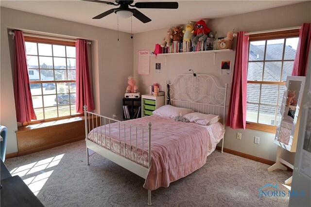 carpeted bedroom with baseboards and a ceiling fan