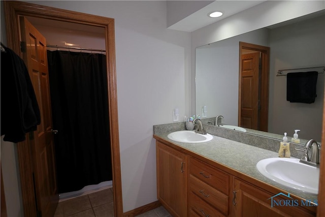 full bathroom with tile patterned flooring, double vanity, and a sink