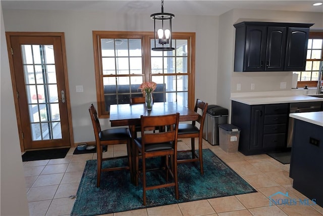 dining area featuring light tile patterned floors and an inviting chandelier