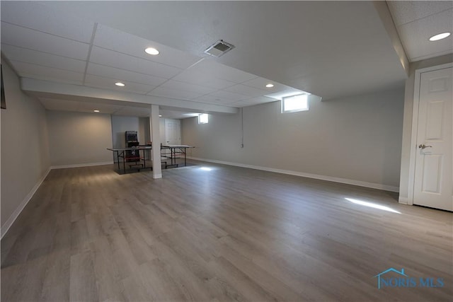 basement with visible vents, baseboards, recessed lighting, wood finished floors, and a paneled ceiling