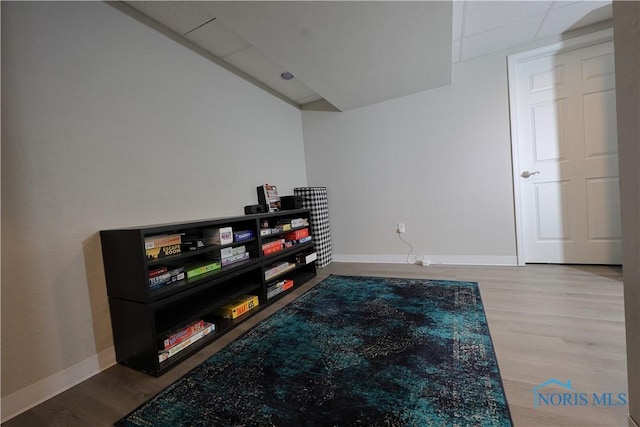 interior space featuring baseboards and wood finished floors