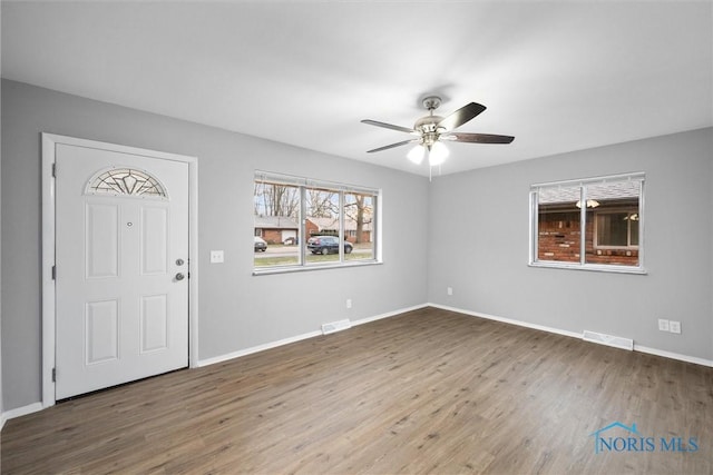 entryway featuring visible vents, a ceiling fan, baseboards, and wood finished floors