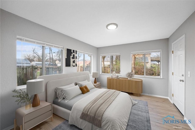 bedroom with wood finished floors and baseboards