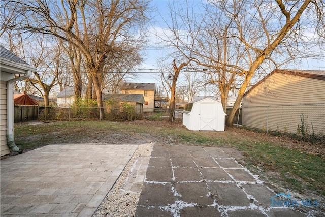 view of patio / terrace featuring an outbuilding, a shed, and a fenced backyard