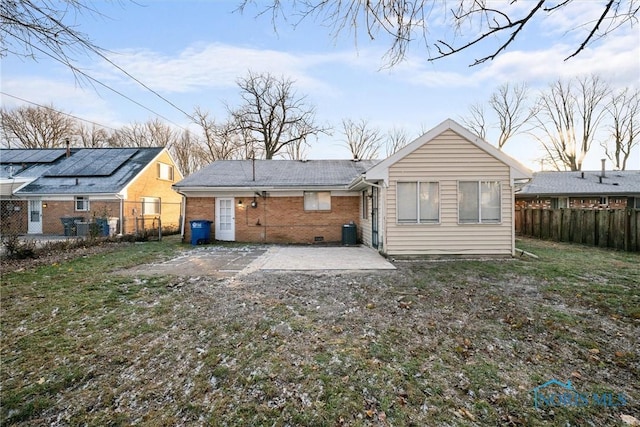 back of house featuring central air condition unit, fence, brick siding, and a patio area