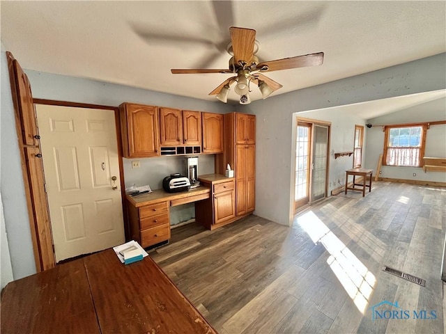 kitchen featuring visible vents, light countertops, brown cabinets, wood finished floors, and a ceiling fan