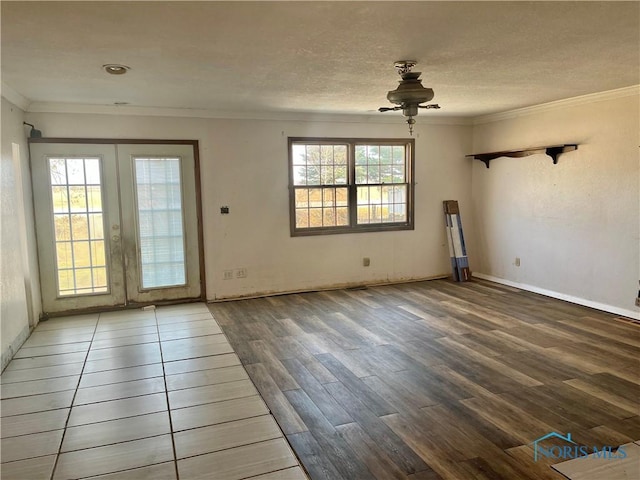 interior space featuring crown molding, wood finished floors, french doors, and a wealth of natural light