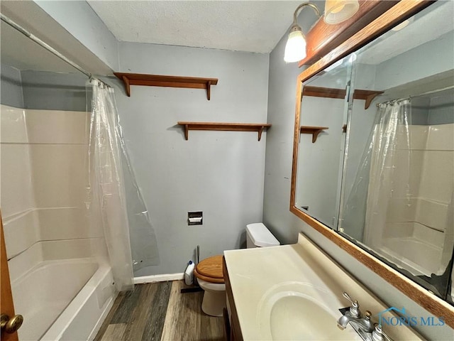 full bathroom featuring toilet, a textured ceiling, wood finished floors, shower / tub combo, and vanity