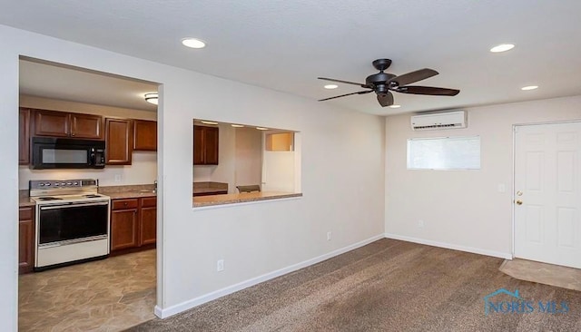 kitchen with baseboards, black microwave, white range with electric cooktop, recessed lighting, and a wall mounted AC