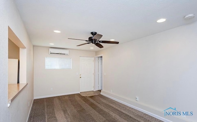 empty room featuring carpet, baseboards, a wall mounted air conditioner, recessed lighting, and a ceiling fan