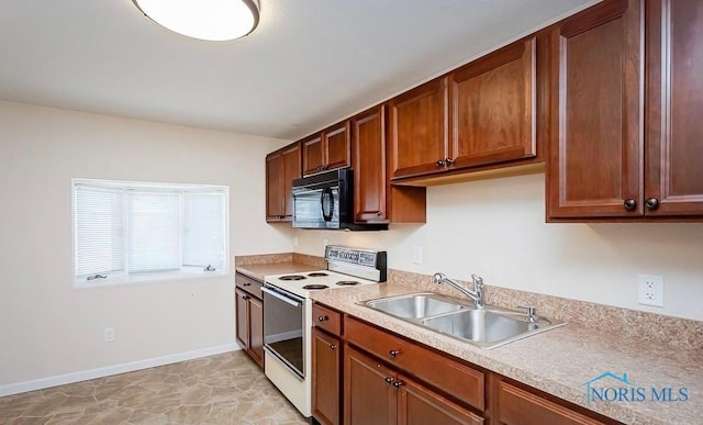 kitchen featuring baseboards, black microwave, light countertops, white electric stove, and a sink