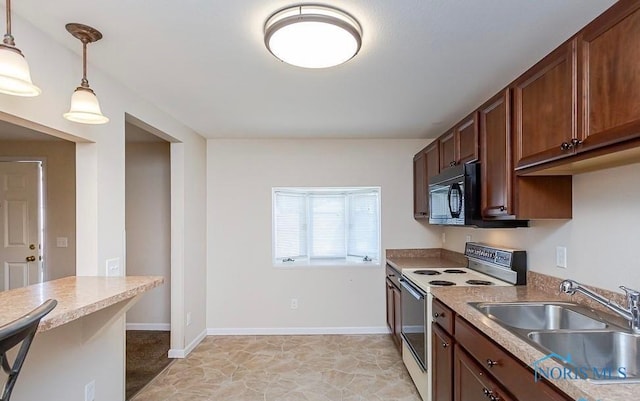 kitchen with black microwave, pendant lighting, light countertops, electric stove, and a sink