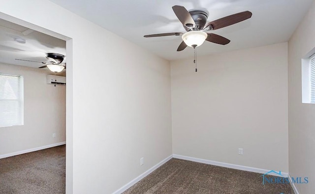 empty room featuring dark carpet, baseboards, and a wall unit AC