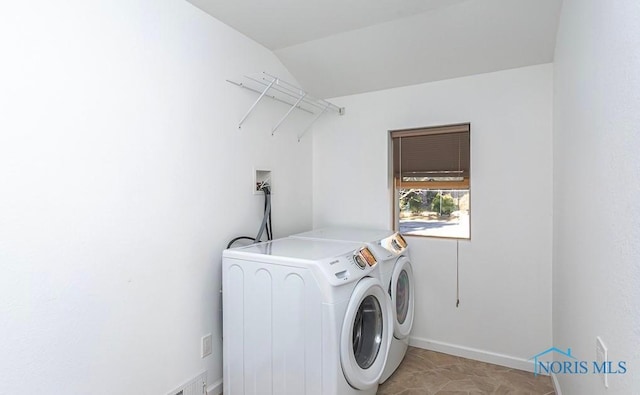 laundry area with baseboards, laundry area, and washing machine and clothes dryer