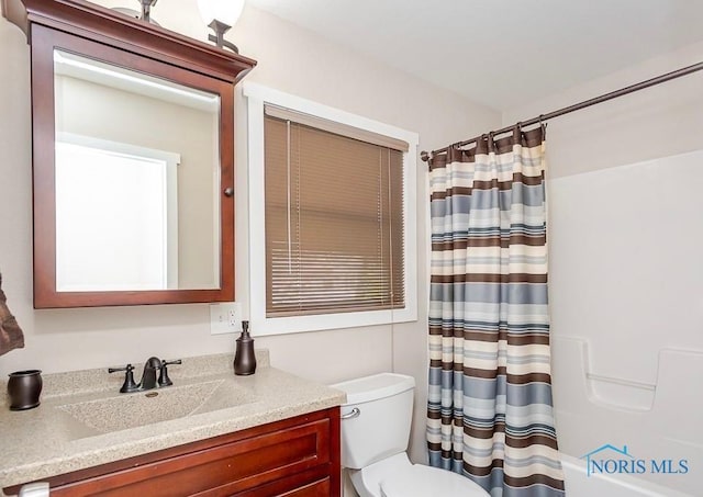 full bath featuring toilet, vanity, and shower / bath combination with curtain