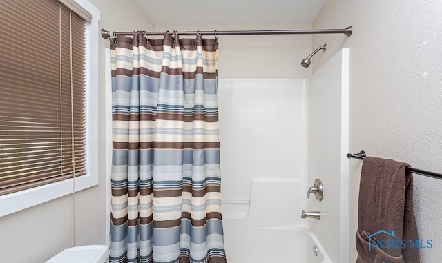 bathroom with shower / bath combo