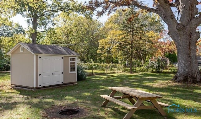 view of shed featuring fence