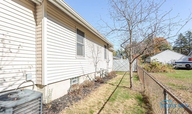 view of side of property featuring central AC unit and fence