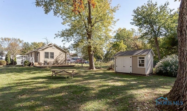 view of yard featuring a storage unit and an outdoor structure