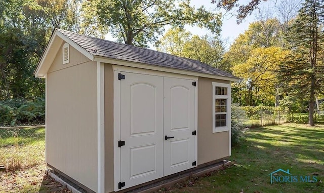 view of shed with fence