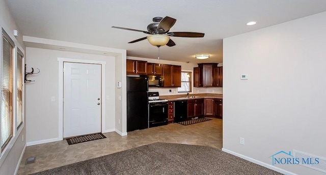 kitchen with baseboards, visible vents, a sink, black appliances, and light countertops