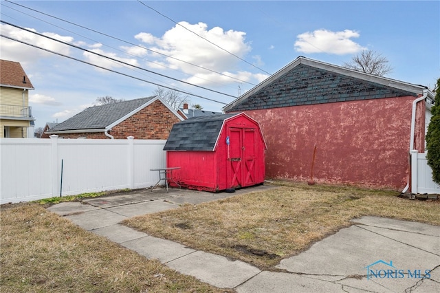 view of shed featuring fence