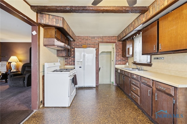 kitchen featuring white appliances, brick wall, beam ceiling, a sink, and light countertops