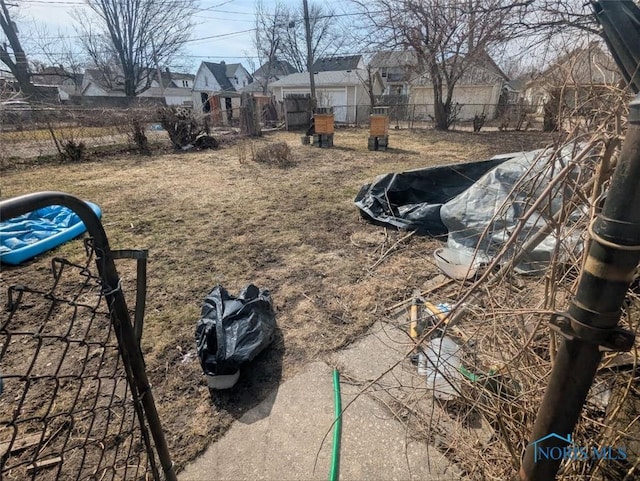 view of yard featuring a residential view and fence