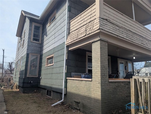 view of property exterior with roof with shingles