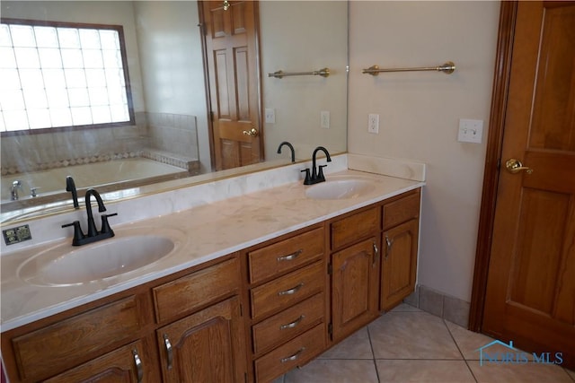 bathroom featuring tile patterned flooring, double vanity, a tub, and a sink