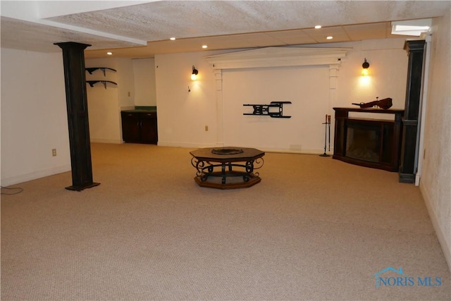 finished basement with carpet flooring, a fireplace, recessed lighting, and baseboards