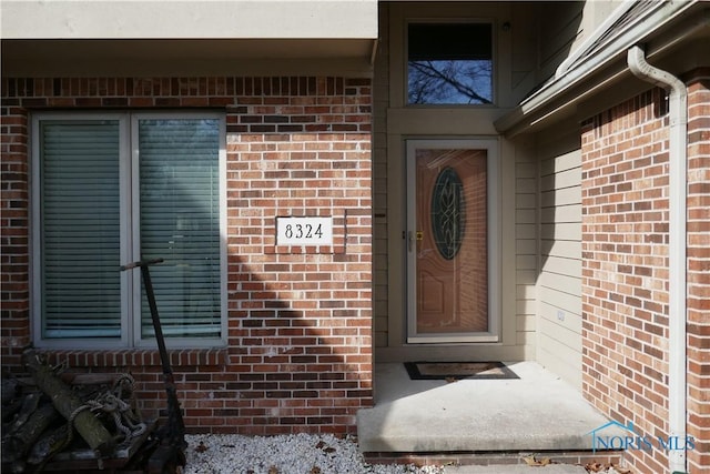 property entrance with brick siding