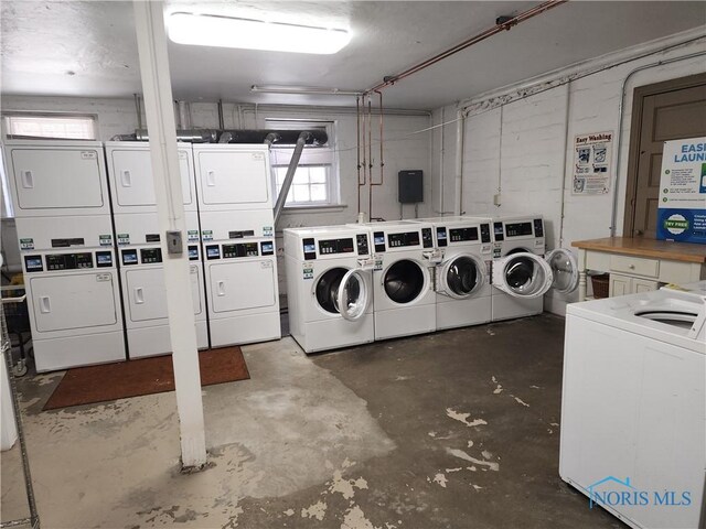 community laundry room featuring independent washer and dryer and stacked washer / drying machine