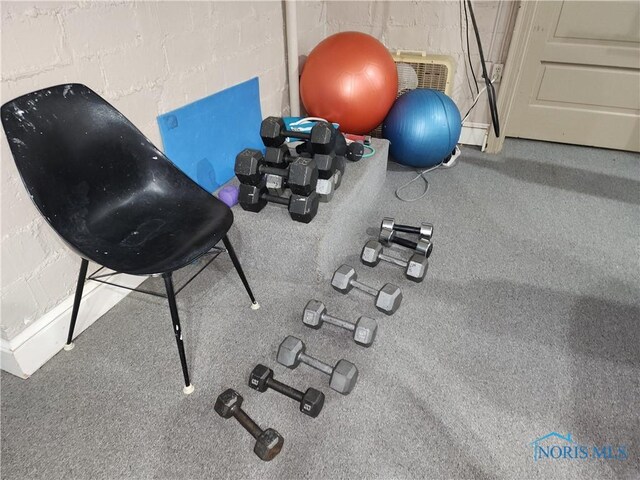 workout room with concrete block wall