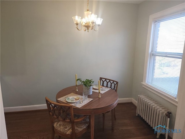 dining area with a notable chandelier, baseboards, radiator, and dark wood-style floors