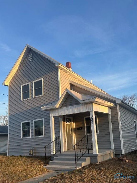 view of front of home featuring a chimney