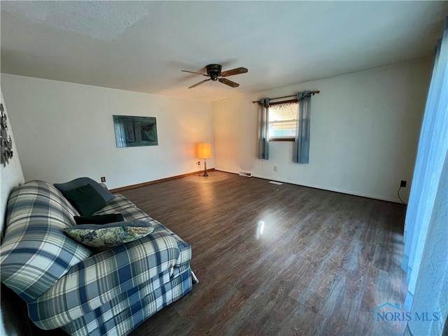 unfurnished living room with visible vents, baseboards, a ceiling fan, and wood finished floors