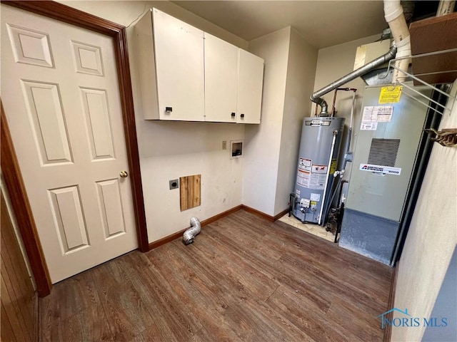 laundry area with electric dryer hookup, washer hookup, gas water heater, cabinet space, and dark wood-style flooring